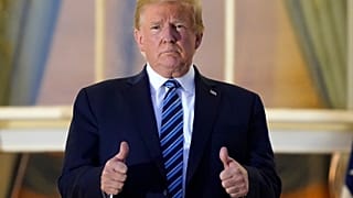 Donald Trump gave a double thumbs up as he re-entered the White House