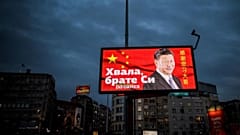 A picture taken on March 30, 2020, shows a billboard bearing Chinese President Xi Jinping's face looking down over a boulevard next to the words "Thank you brother Xi" 