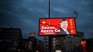 A picture taken on March 30, 2020, shows a billboard bearing Chinese President Xi Jinping's face looking down over a boulevard next to the words "Thank you brother Xi" 