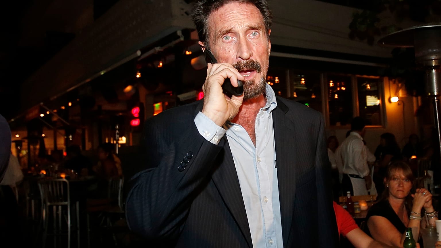 John McAfee pictured in 2012 on his mobile phone in the South Beach area of Miami.