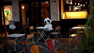 Panda bear cuddly toys rest in an empty terrace of a restaurant in downtown Brussels, Saturday, Oct. 3, 2020. 
