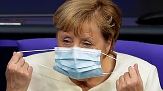 German Chancellor Angela Merkel adjusts her face mask. Berlin, Germany, September 29, 2020. 