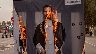 Activists of Catalonia's pro-independence grassroots group, ANC, burn a portrait of Spain's King Felipe VI during a demonstration in Barcelona on Friday, October 9, 2020.