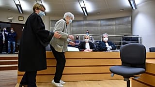 Clara Maes, 89, is helped to her seat in the courtroom where she was found guilty of murder