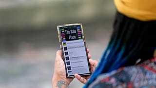 Jasmin Pierre with her smartphone app, a free Black-oriented mental health app that's seen more signups during the pandemic, New Orleans, July 2, 2020.