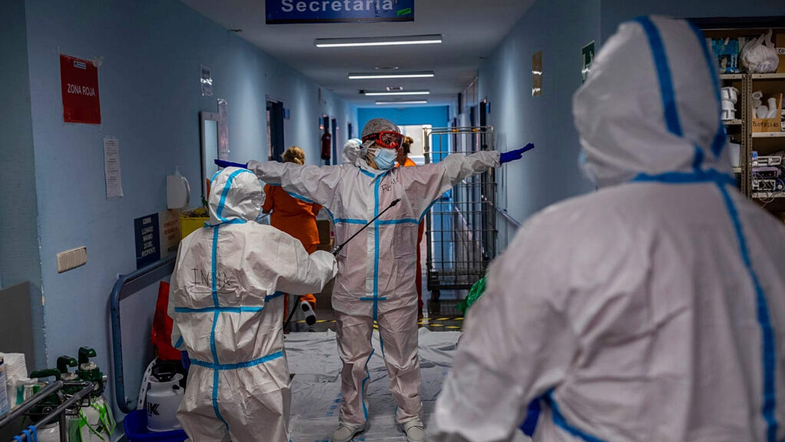 FILE - In this Oct. 9, 2020, file photo, a medical team member is disinfected before leaving the COVID-19 ward at a hospital in Leganes, outskirts of Madrid, Spain.