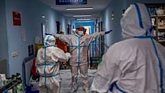FILE - In this Oct. 9, 2020, file photo, a medical team member is disinfected before leaving the COVID-19 ward at a hospital in Leganes, outskirts of Madrid, Spain.