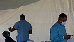 A health worker carries out COVID-19 tests of a resident of Larnaca, a resort town in southern coast of Cyprus