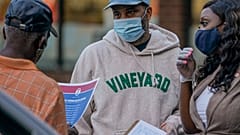  New York City Council member Farah Louis, right, pass out voter information in the Brooklyn borough of New York, Friday, Sept. 18, 2020.