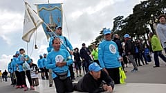 A group of pilgrims paying penance move towards the Chapel of the Apparitions at the Fatima Sanctuary Thursday, May 11 2017, in Fatima, Portugal.