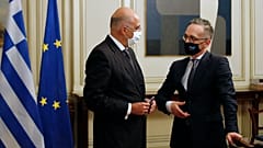 Germany's foreign minister Heiko Maas, right, speaks with his Greek counterpart Nikos Dendias 