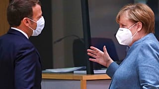 German Chancellor Angela Merkel, right, speaks with French President Emmanuel Macron