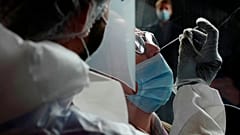 A woman has a nose swab taken for a COVID-19 test at Lille Zenith Arena in Lille, northern France