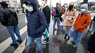 Personas esperan en la parada de un tranvía en la frontera entre Francia y Alemania