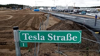 a street sign reading 'Tesla Street 1' stand in front of the construction site of the electric car Tesla Gigafactory in Gruenheide near in Berlin, Germany. 