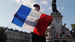 A demonstrator at a rally in honour of murdered teacher Samuel Paty