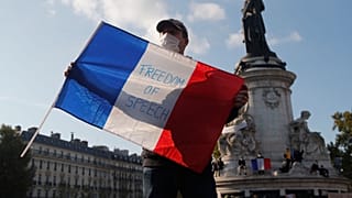 A demonstrator at a rally in honour of murdered teacher Samuel Paty