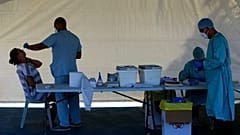 A health worker carries out a COVID-19 test of a resident of Larnaca