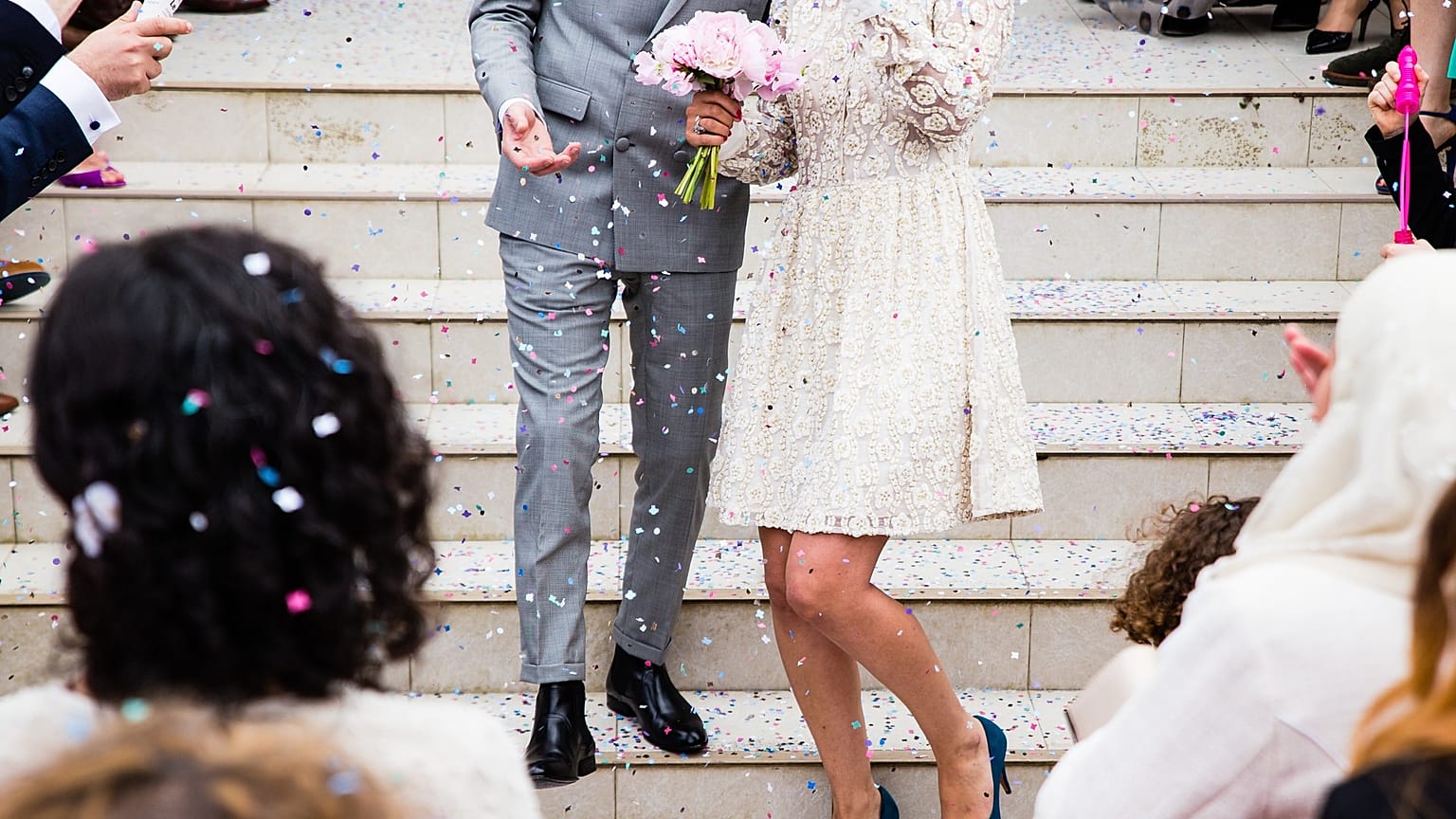 File photo: A bride and groom are pictured surrounded by wedding guests.