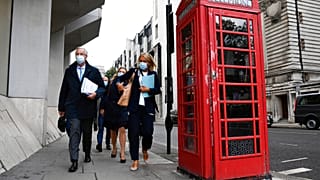 Chief EU negotiator Michel Barnier, left, makes his way to the Department for Business, Energy & Industrial Strategy, in London, Wednesday, Sept. 23, 2020. 