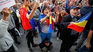 People shout slogans during a protest against the use of face masks and the protection measures against the COVID-19 infections in Bucharest, Romania, Saturday, Oct. 10, 2020