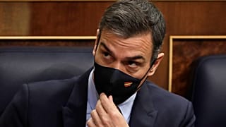 Spain's Prime Minister Pedro Sanchez adjusts his face mask at a parliamentary session ahead of a no-confidence vote. Madrid, Spain. October 21, 2020.