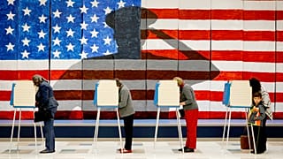 FILE: Voters line up in voting booths to cast their ballots at Robious Elementary School in Chesterfield, VA, 8 November 2016