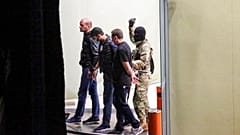 A gunman could be seen escorting three individuals out of the bank building on Wednesday.
