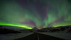 Northern Lights, or aurora borealis, appear in the sky over Bifrost, Western Iceland.