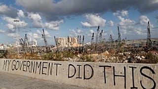 Political graffiti is visible in front of the scene of the August 4 explosion that hit the seaport of Beirut, Lebanon.