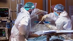 Medical staff of the Intensive Care Unit of the Casalpalocco COVID-19 Clinic in the outskirts of Rome tend to patients, Wednesday, Oct. 21, 2020.