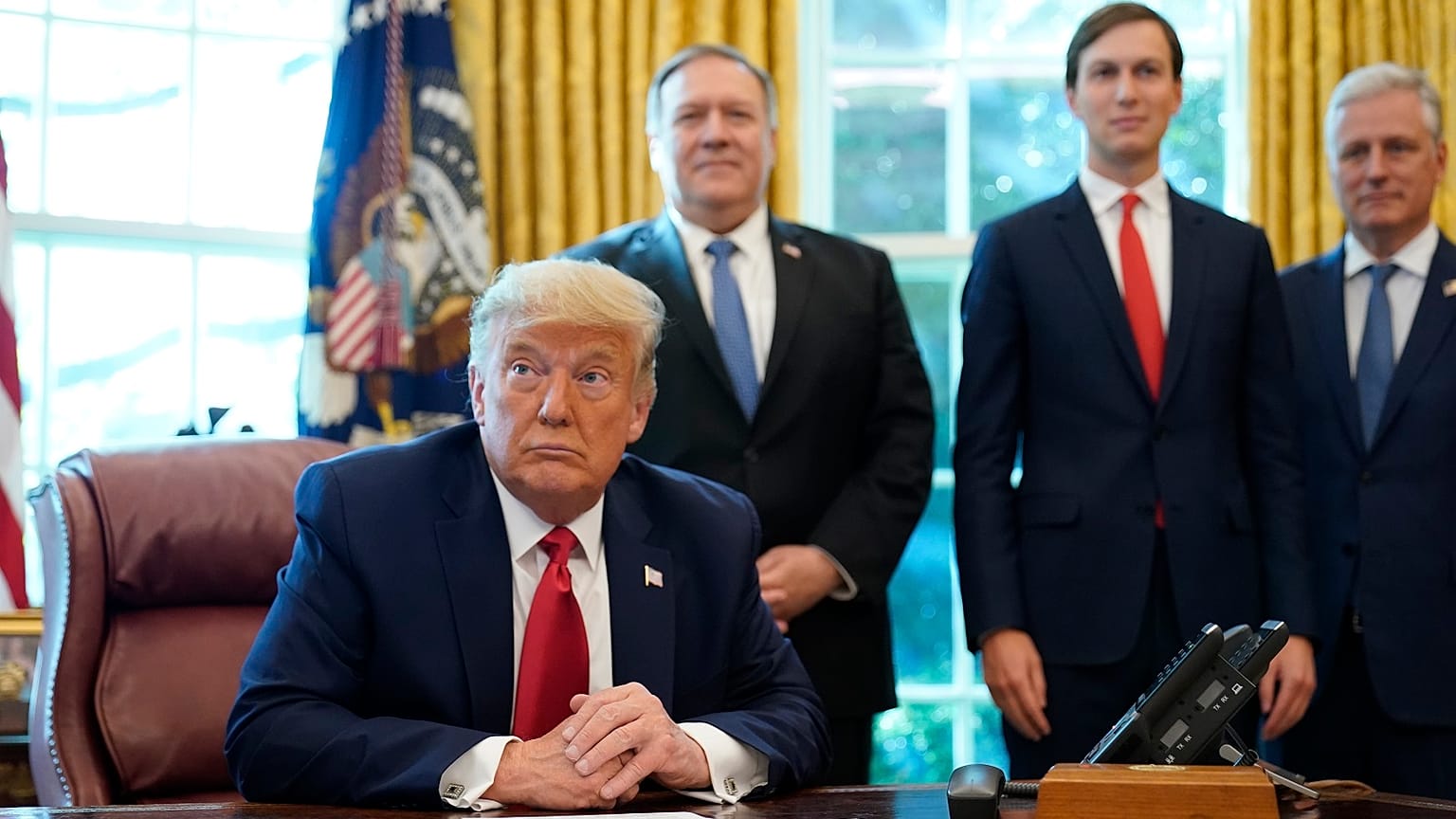 President Donald Trump listens while on a phone call with leaders of Sudan and Israel in the Oval Office of the White House, Friday, Oct. 23, 2020.