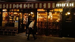 A waiters cleans the terrace of a restaurant before the nightly curfew due to the restrictions against the spread of the Coronavirus disease, in Paris
