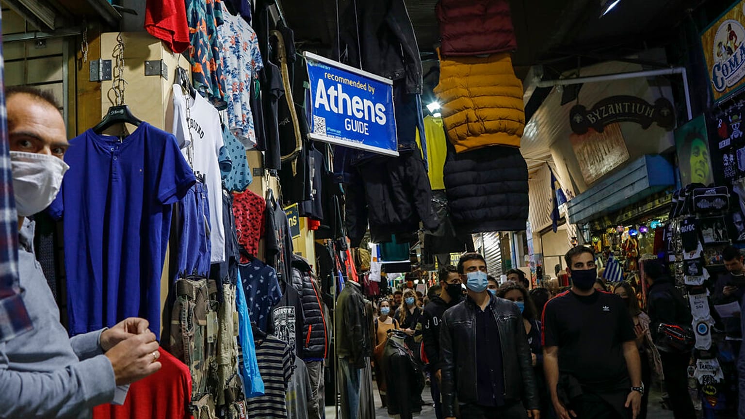 University students wearing face masks to curb the coronavirus protest as they walk in Monastiraki flea market in Athens
