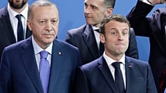 Turkey's President Recep Tayyip Erdogan, left and French President Emmanuel Macron stand, during a group photo at a conference on Libya in Berlin.