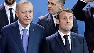 Turkey's President Recep Tayyip Erdogan, left and French President Emmanuel Macron stand, during a group photo at a conference on Libya in Berlin.