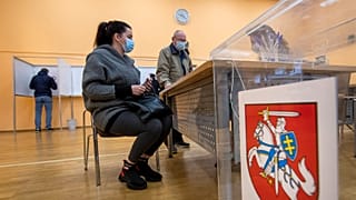 Lithuanians wait for ballots at a polling station during early voting in the second round of elections in Vilnius, Lithuania, on Thursday, October 22, 2020.