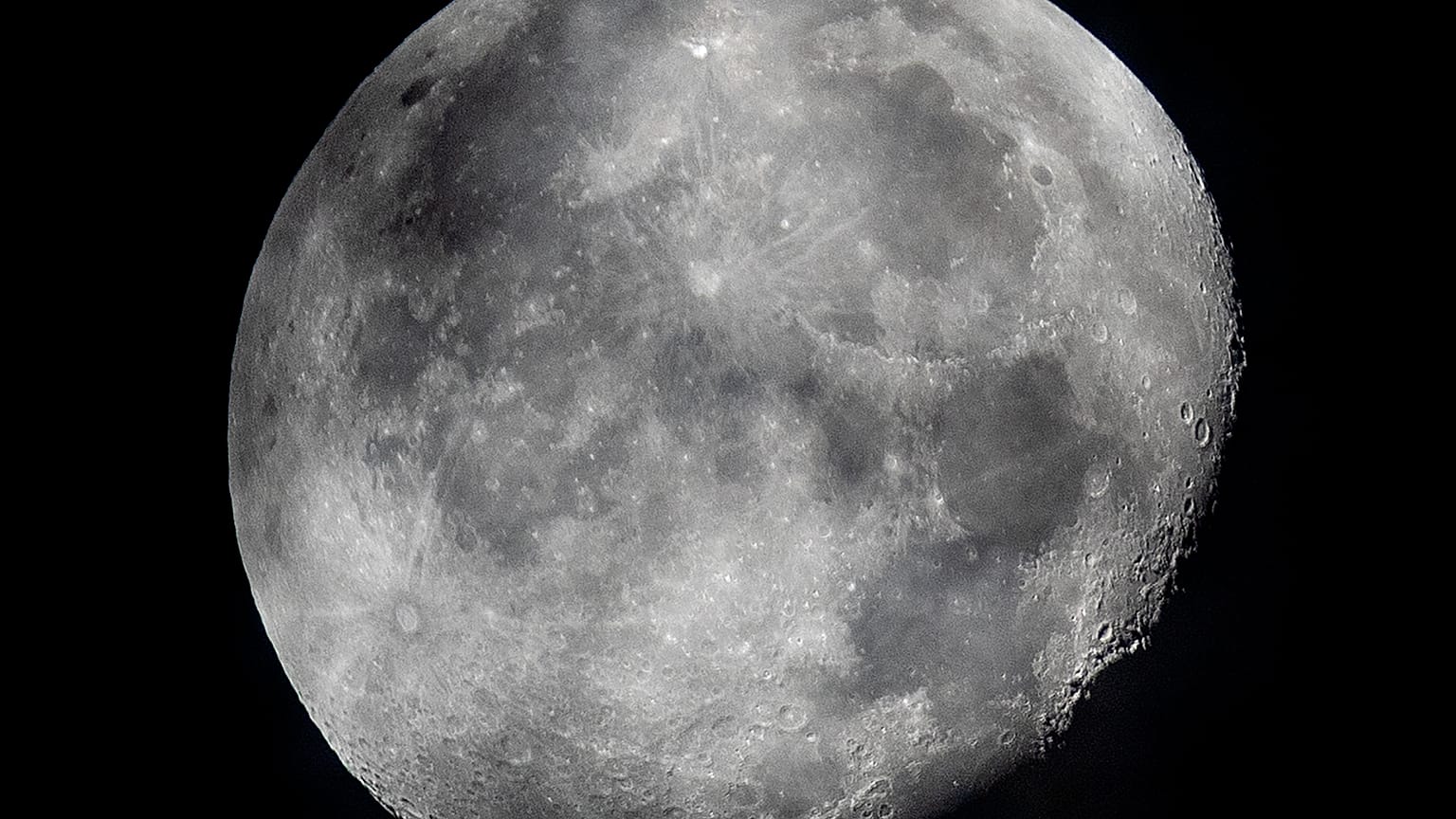 In this early Monday, Oct. 5, 2020, file photo, a waning moon is seen at the sky over Frankfurt, Germany. The moon’s shadowed, frigid nooks and crannies may hold frozen water 