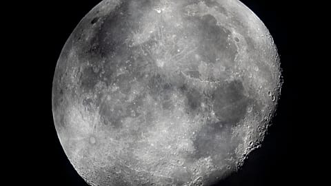 In this early Monday, Oct. 5, 2020, file photo, a waning moon is seen at the sky over Frankfurt, Germany. The moon’s shadowed, frigid nooks and crannies may hold frozen water 