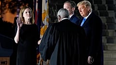 President Donald Trump watches as Supreme Court Justice Clarence Thomas administers the Constitutional Oath to Amy Coney Barrett on Monday October 26, 2020.