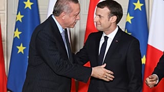 Turkish President Recep Tayyip Erdogan, left, and French President Emmanuel Macron arrives for a press conference at the Elysee Palace in Paris, Friday, Jan.5, 2018