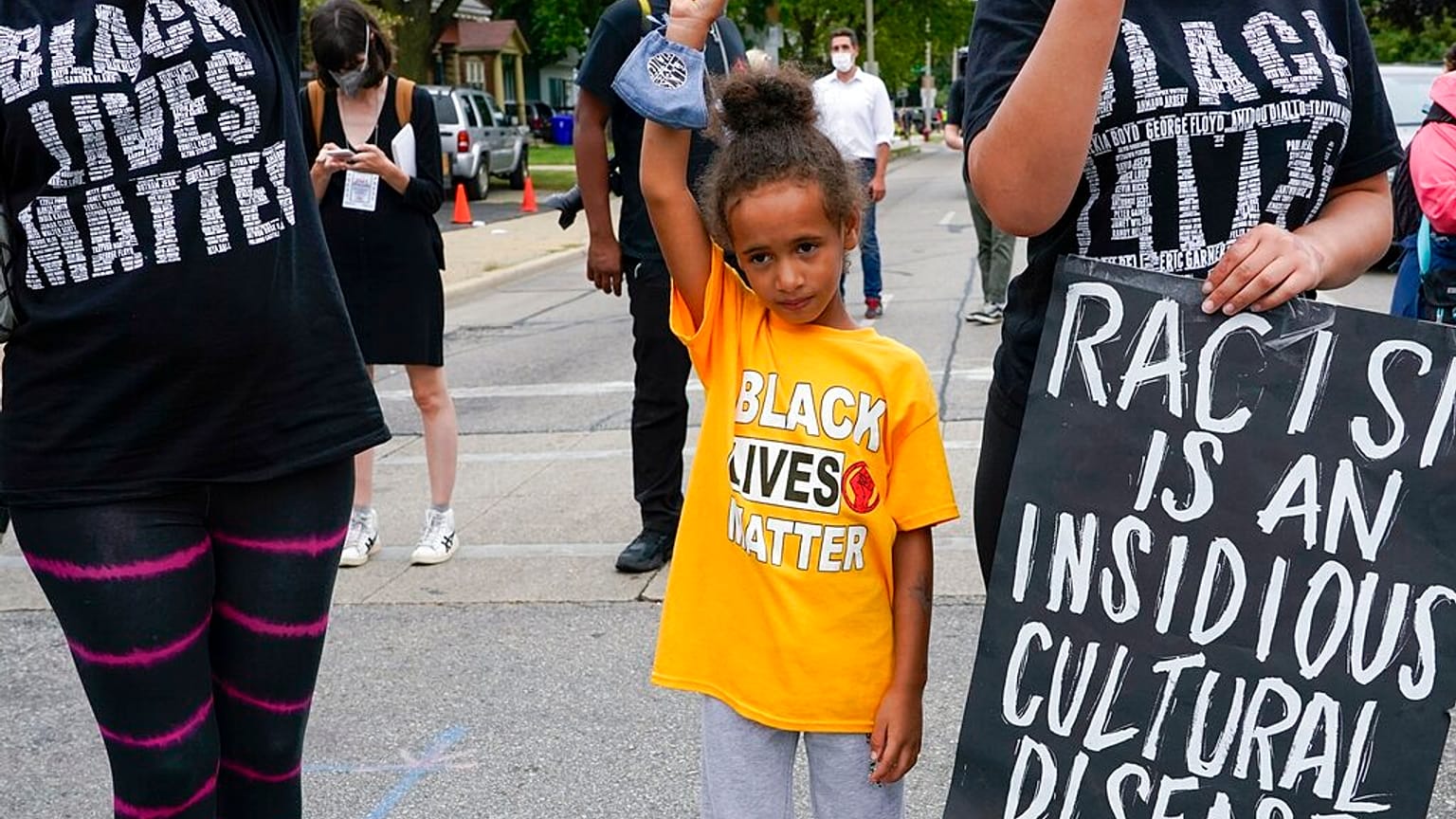 Six-year-old Deja holds her hand in the air during a Black Lives Matter protest Tuesday, Sept. 1, 2020, in Kenosha, Wis. 