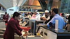 In this Monday, June 12, 2017 photo, Qatari and other nationals queue at the check in counters of the Hamad International Airport in Doha, Qatar