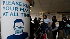 Passengers queue at the O.R. Tambo Airport in Johannesburg on October 1. after the airport reopened some international flights, ending a six-month ban on international travel.