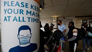 Passengers queue at the O.R. Tambo Airport in Johannesburg on October 1. after the airport reopened some international flights, ending a six-month ban on international travel.