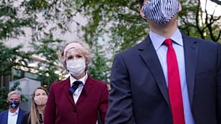 E. Jean Carroll, centre, who says President Donald Trump raped her in the 1990s, leaves the courthouse following a hearing in her defamation suit.