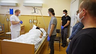 Volunteers take part in a one-day course, as part of a programme by the Czech Red Cross to create thousands of voluntary healthcare assistants, in a hospital in Prague.