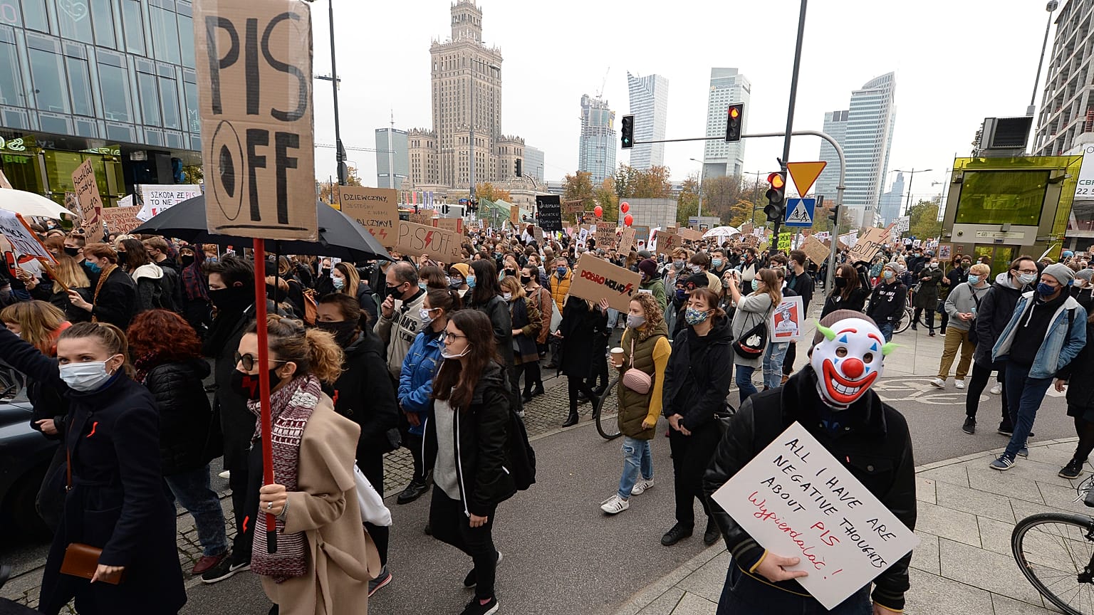 Women's rights activists with posters of the Women's Strike action protest in Warsaw, Poland, Wednesday, Oct. 28, 2020.