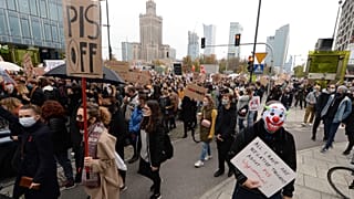 Women's rights activists with posters of the Women's Strike action protest in Warsaw, Poland, Wednesday, Oct. 28, 2020.