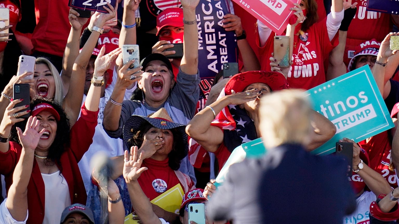 President Donald Trump acknowledges the cheering crowd behind him at a campaign rally at Phoenix Goodyear Airport Wednesday, Oct. 28, 2020, in Goodyear, Arizona.